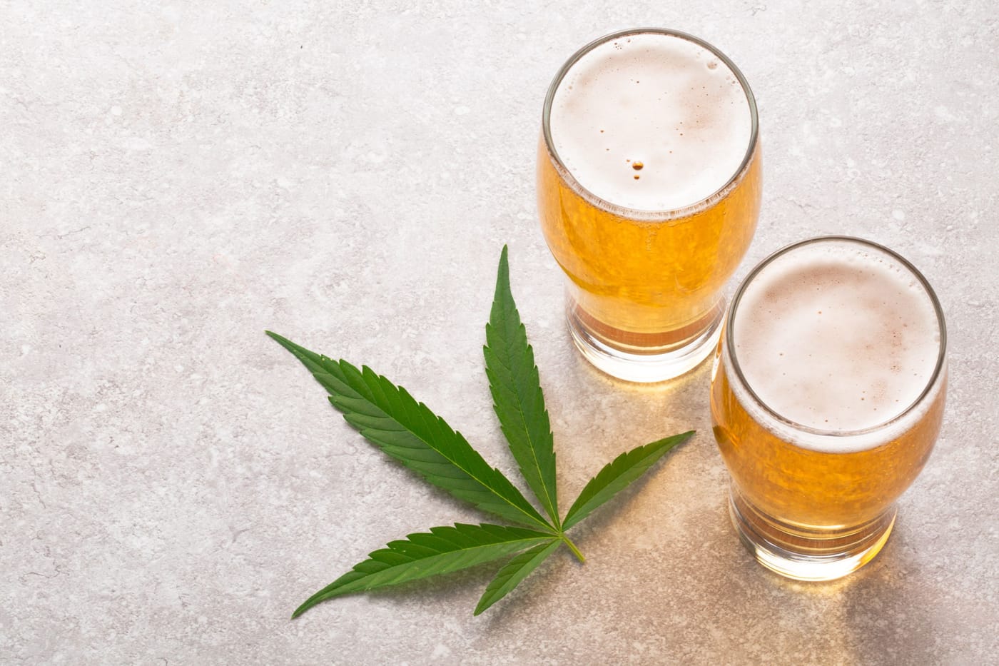 Beer bottles and cannabis representing YouGov survey finding 64 percent of Americans now consider regular alcohol use more dangerous than marijuana