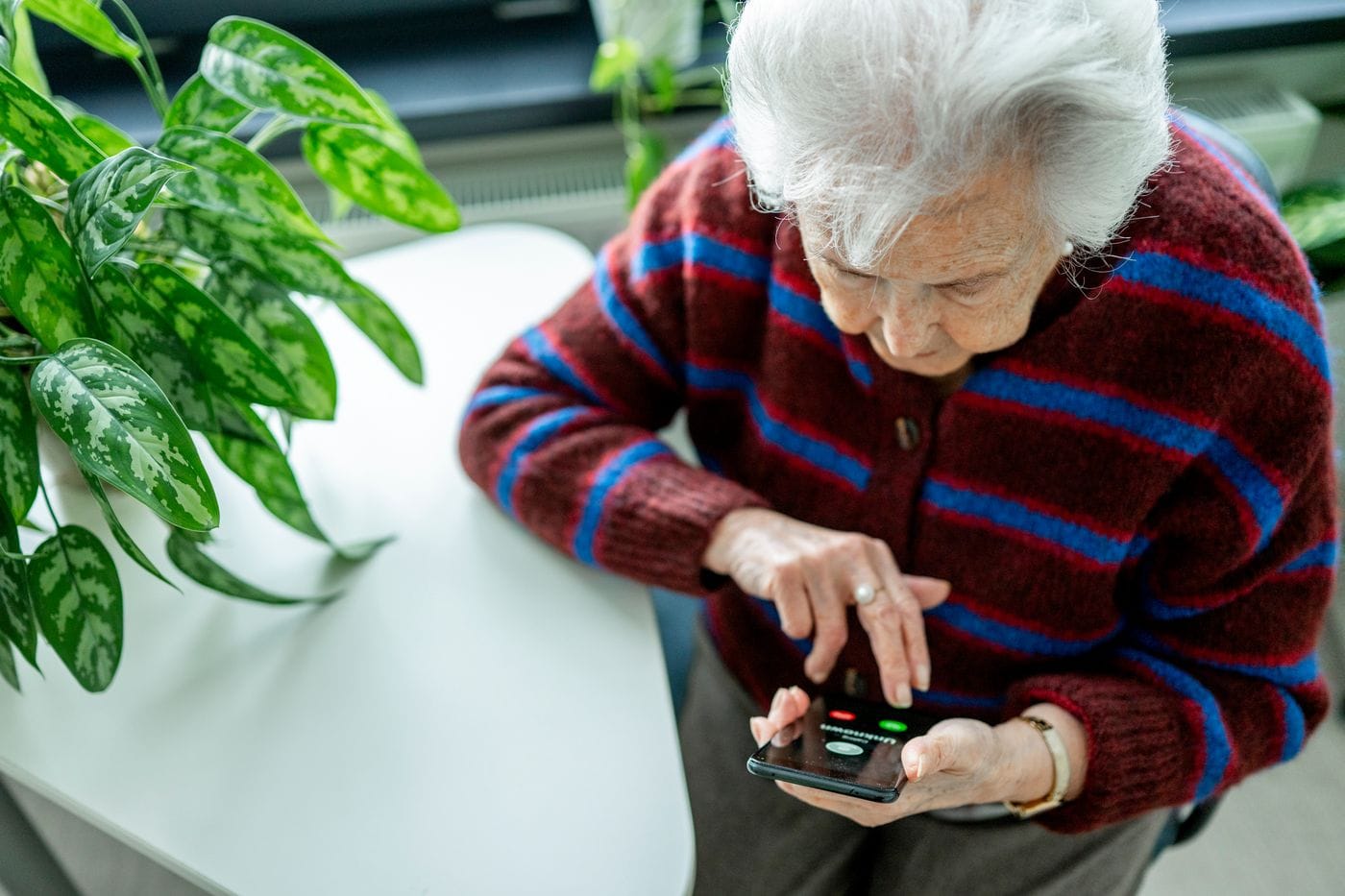 An elderly person reviewing financial documents representing the bipartisan Financial Exploitation Prevention Act passing the US House 419-0 giving investment companies the ability to pause transactions suspected to involve elder fraud