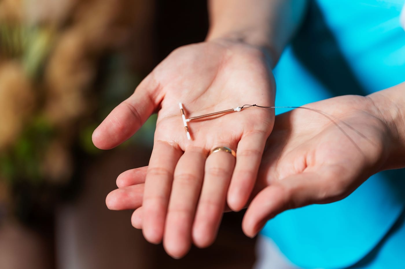 A hand holding an IUD representing Dr. Roshni Kakaiya's paracervical block training model designed to reduce pain during IUD insertion procedures