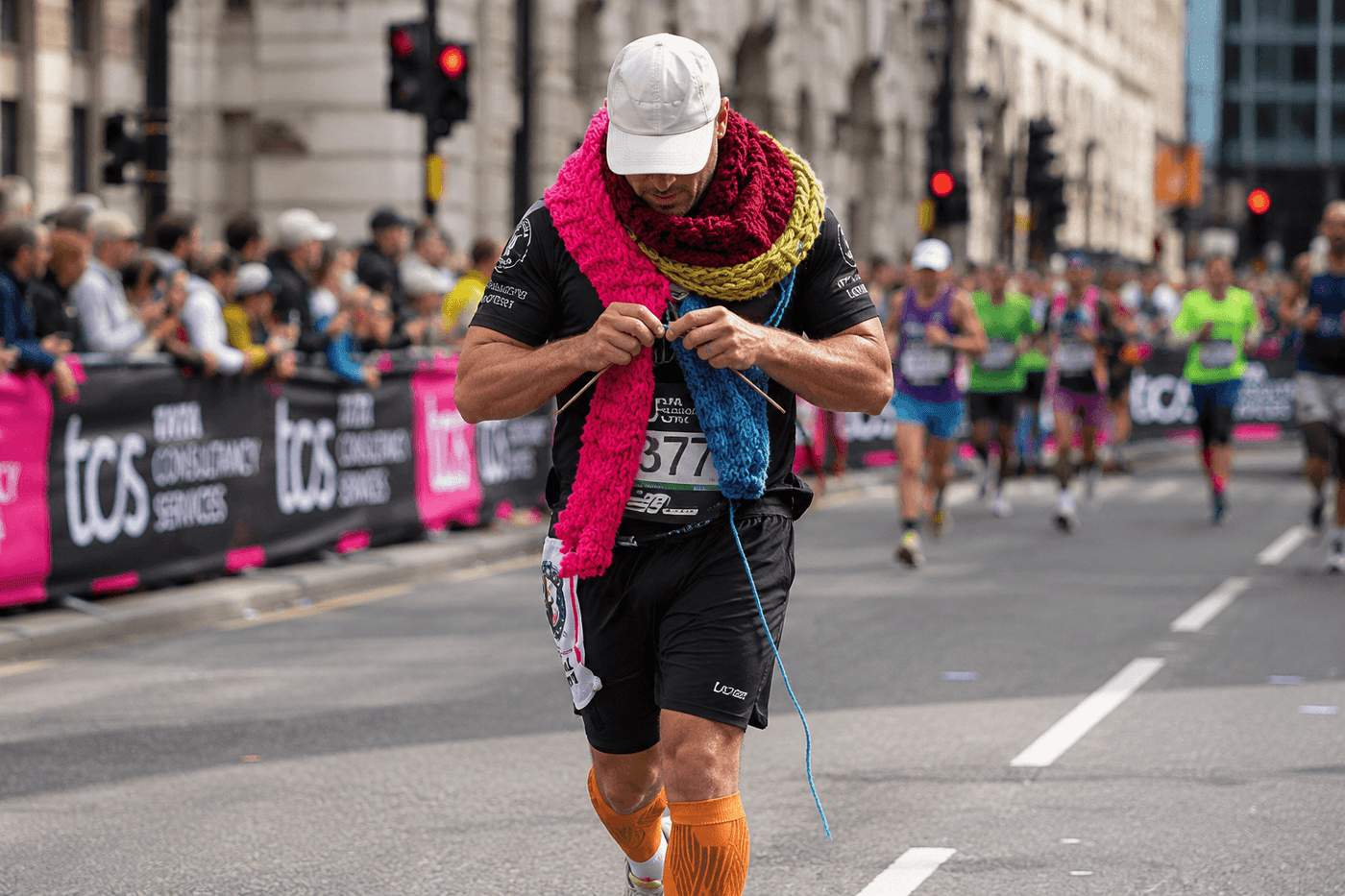 Simon Fannon running the 2026 TCS London Marathon while knitting a 5.59 metre scarf to set a Guinness World Record
