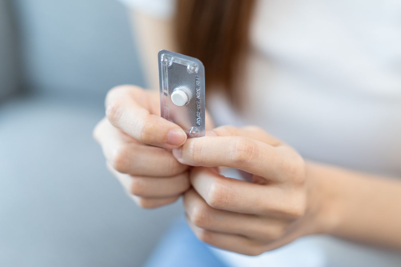 woman holding pill