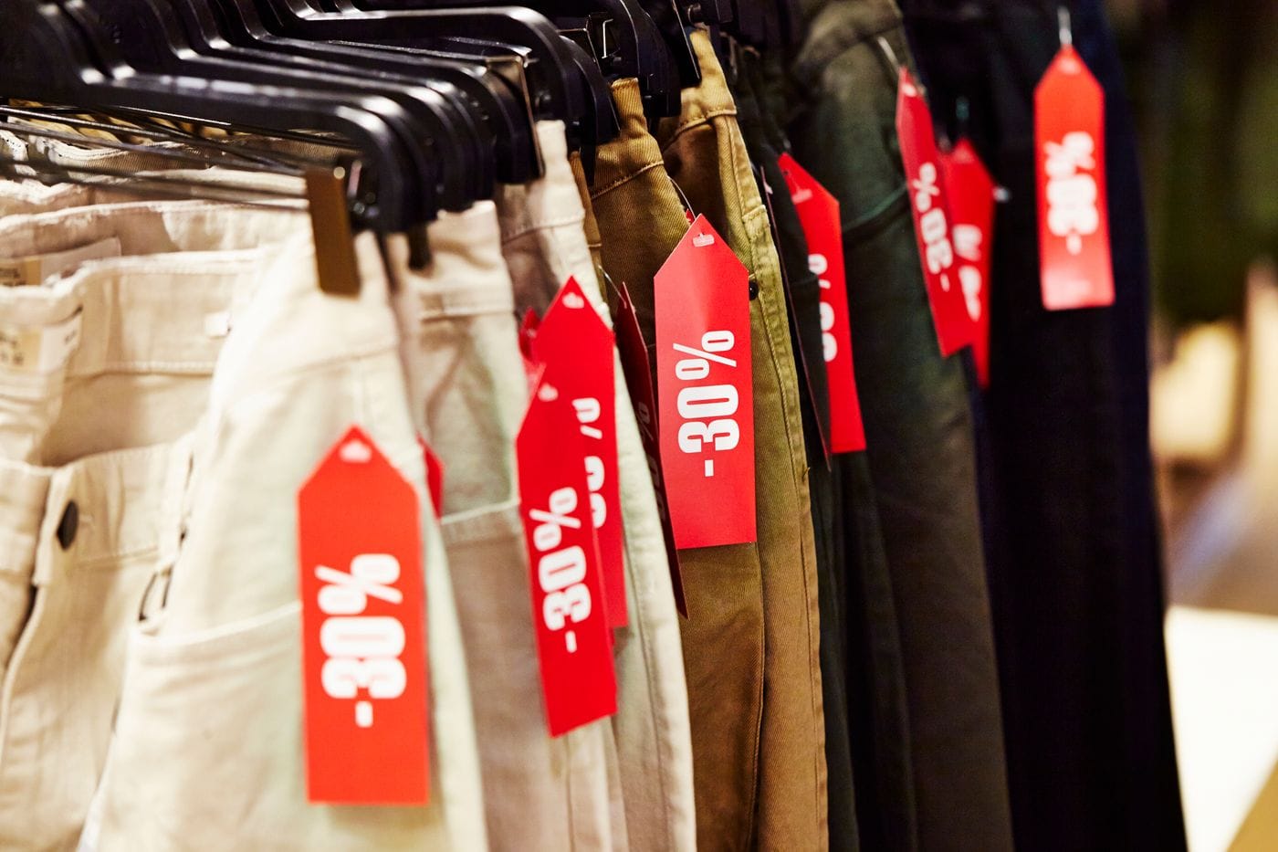 Piles of discarded fast fashion clothing representing France's Parliament unanimously passing its landmark anti-fast-fashion law on June 29 2026 targeting Shein Temu and AliExpress with per-item fees and an advertising ban