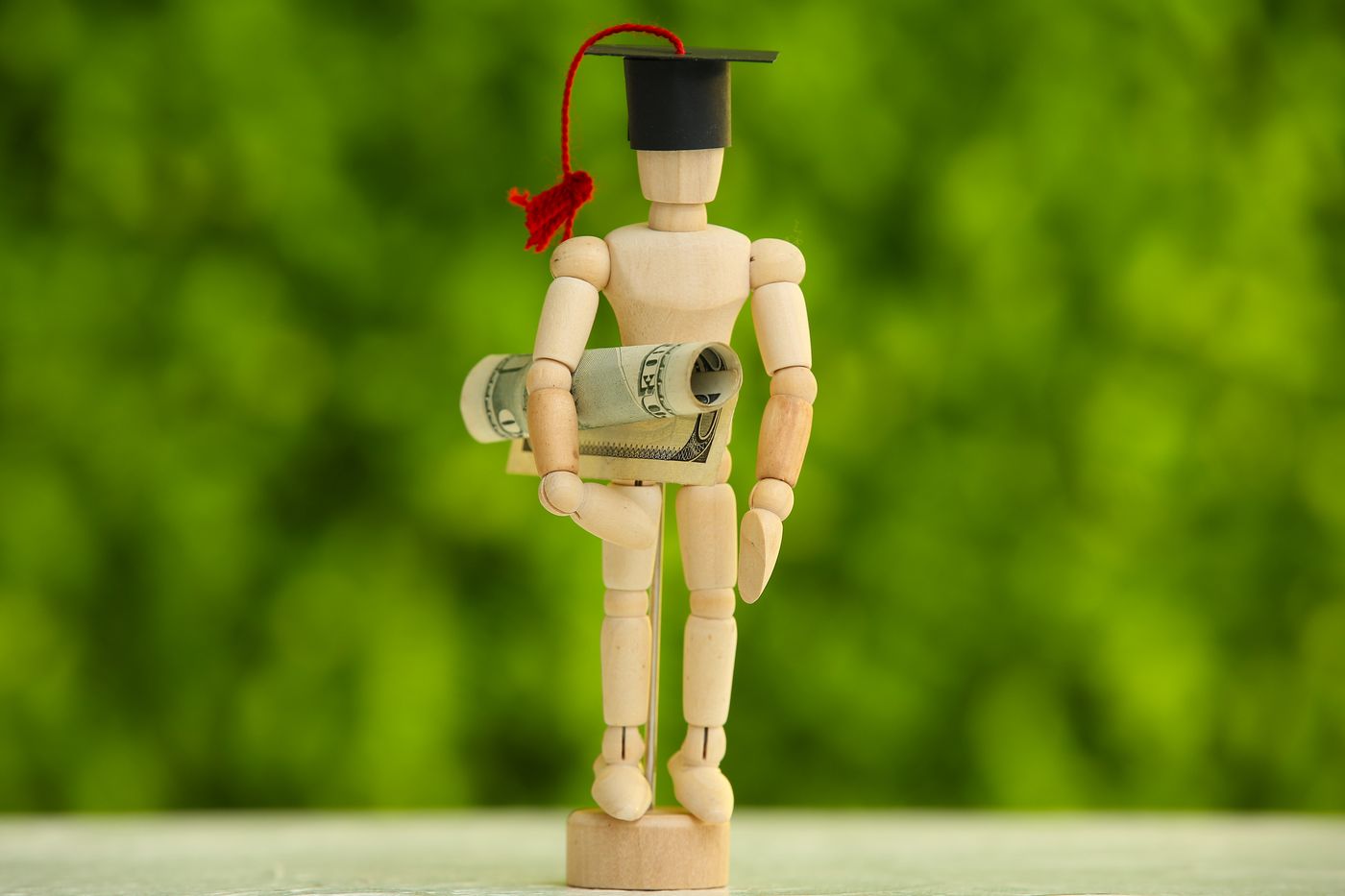 A college graduate in cap and gown holding a diploma representing the 9th US Circuit Court of Appeals ruling in July 2026 that automatically cancelled $11 billion in student loans for 170000 borrowers defrauded by for-profit colleges under the Sweet v McMahon class-action settlement