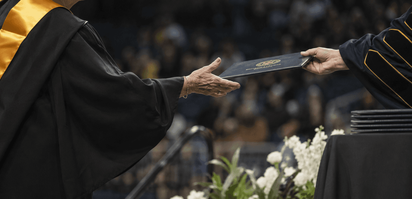 Irma Garcia age 72 graduating from George Mason University with a bachelor's degree in public administration alongside her three daughters