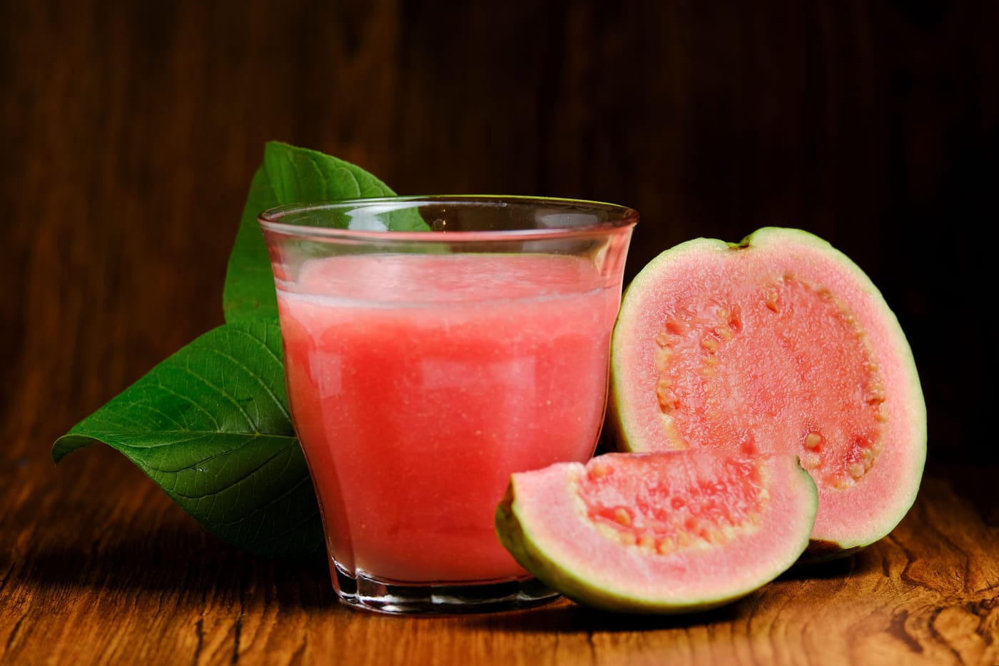 Fresh guava juice in a mason jar on a wooden table representing BMJ Nutrition Prevention Health study on guava juice and iron absorption for anemia prevention