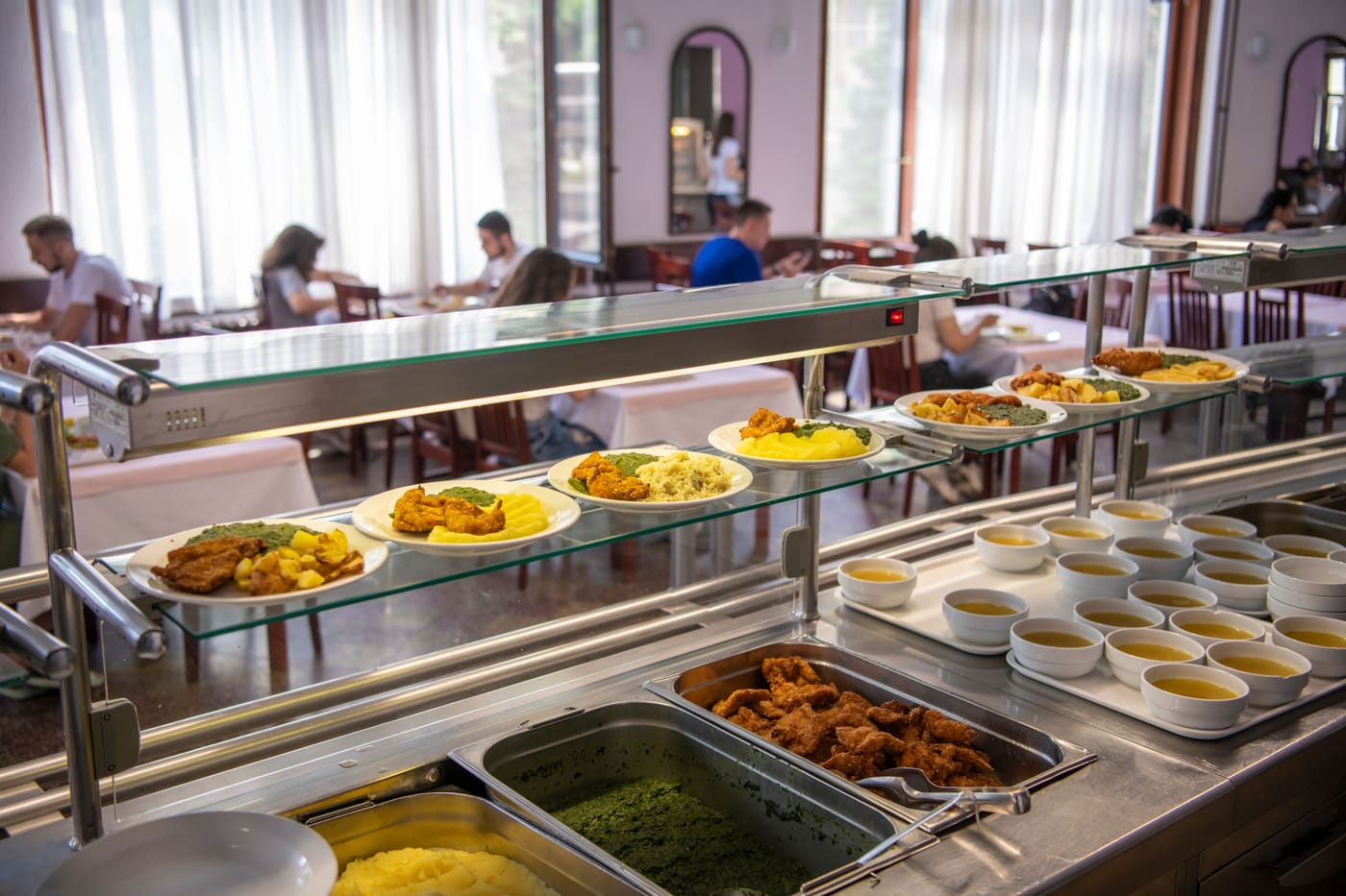 Students eating lunch at a French university canteen where one-euro meals are now available to all students