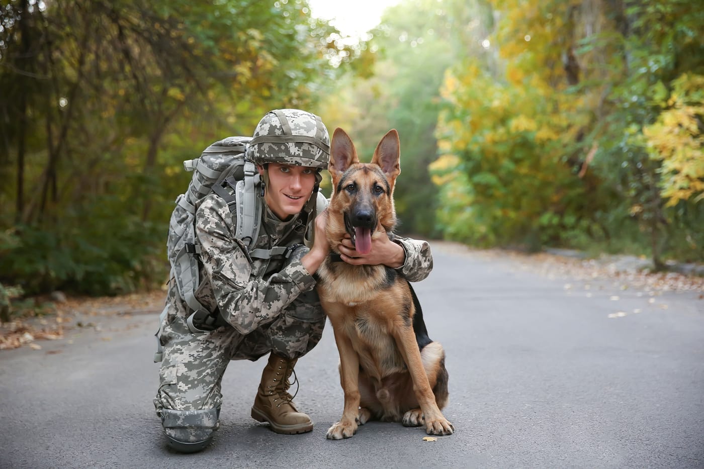 Senior Airman Alex Jones reuniting with retired military working dog Max at a Paws of War ceremony in Sneads Ferry North Carolina in May 2026