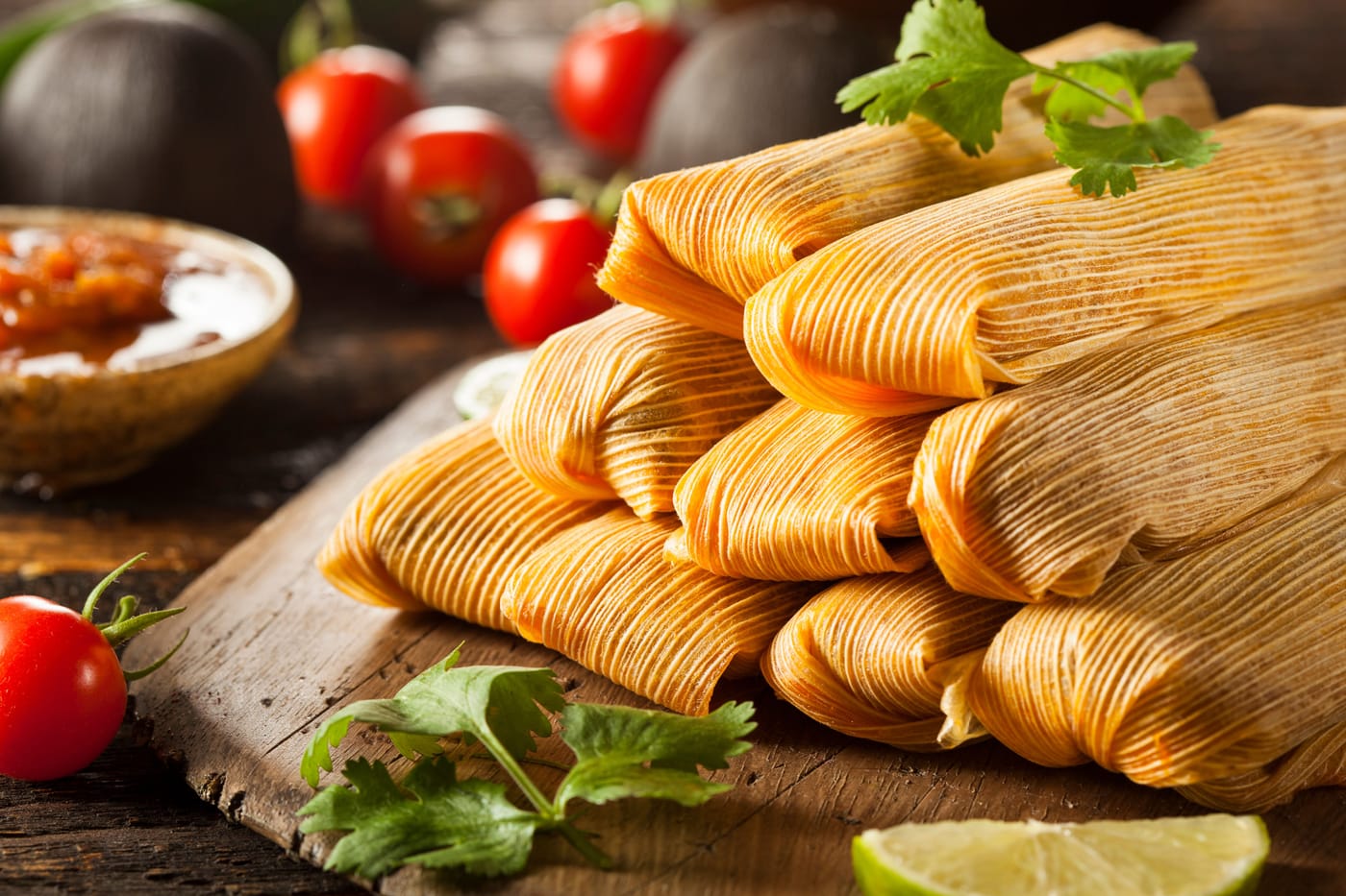 Freshly made tamales on a platter representing Colorado Governor Jared Polis signing the Tamale Act expanding the state Cottage Foods Act to allow home cooks to legally sell temperature-controlled foods