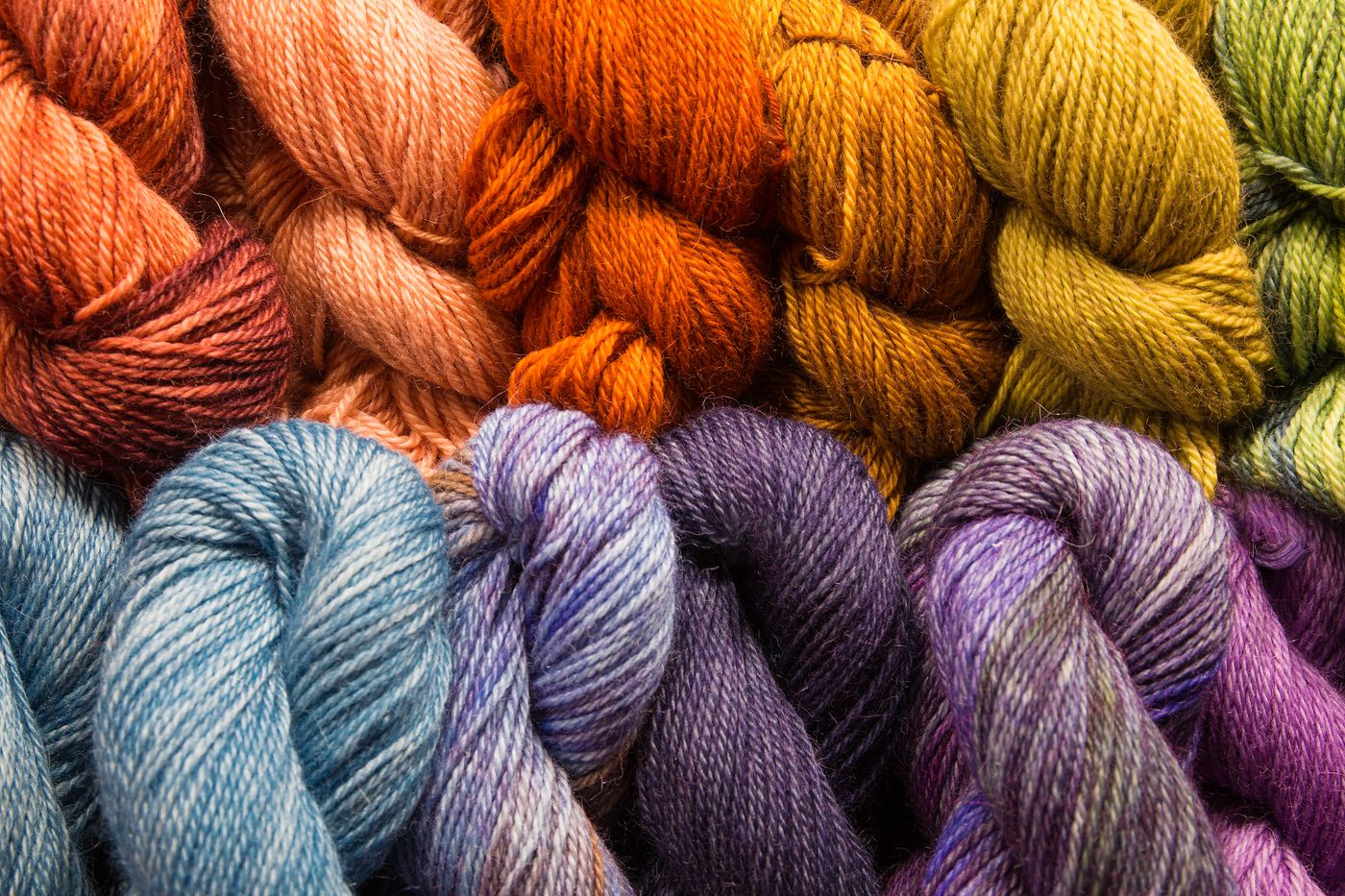 Colorful spools of yarn representing MIT research scientist Svetlana Boriskina's recyclable polyethylene yarn published in ACS Materials Letters that can be woven into clothing melted down and respun up to 10 times with no loss of elasticity or strength
